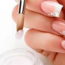 Pennello che modella l'acrilico su un'unghia